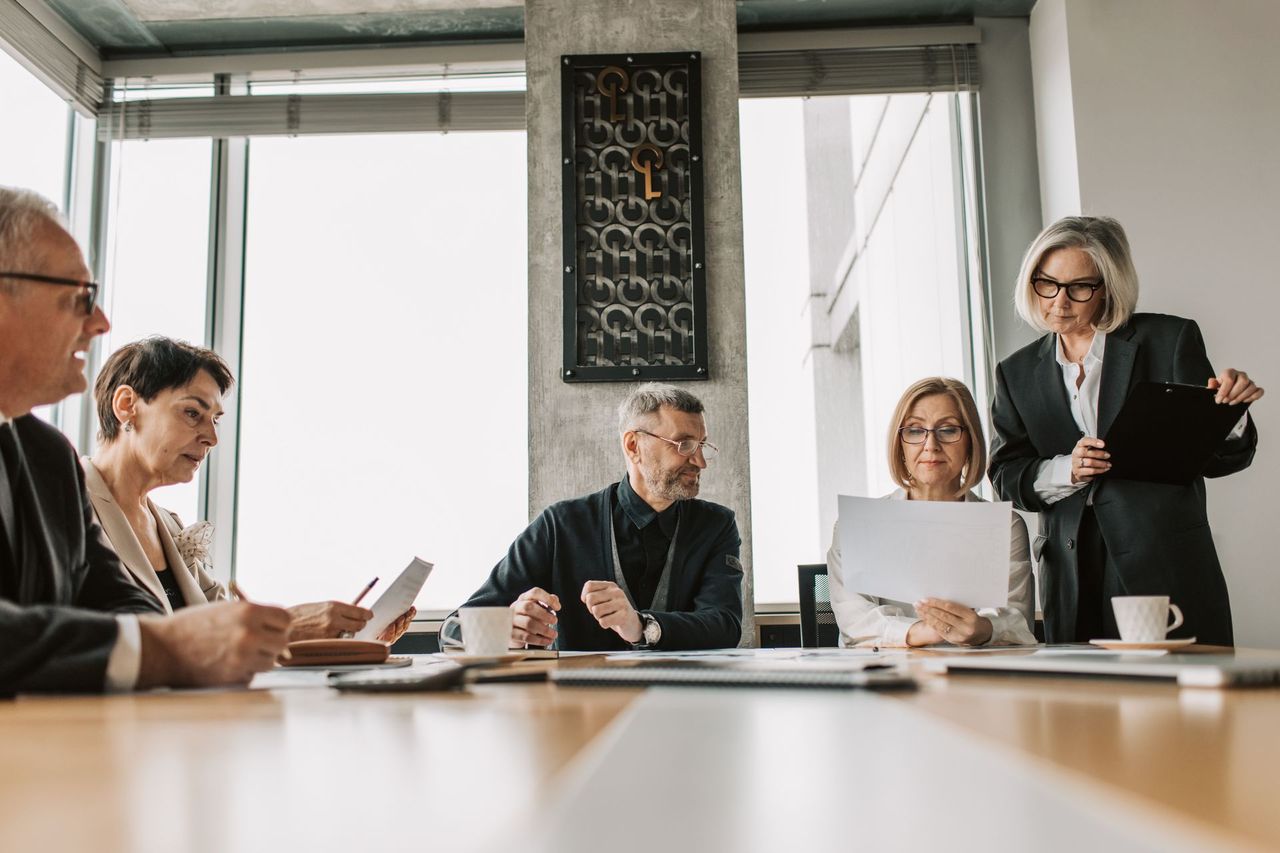 Adviseurs van Jouhar Expertise Bureau in gesprek met een cliënt over financiële documenten